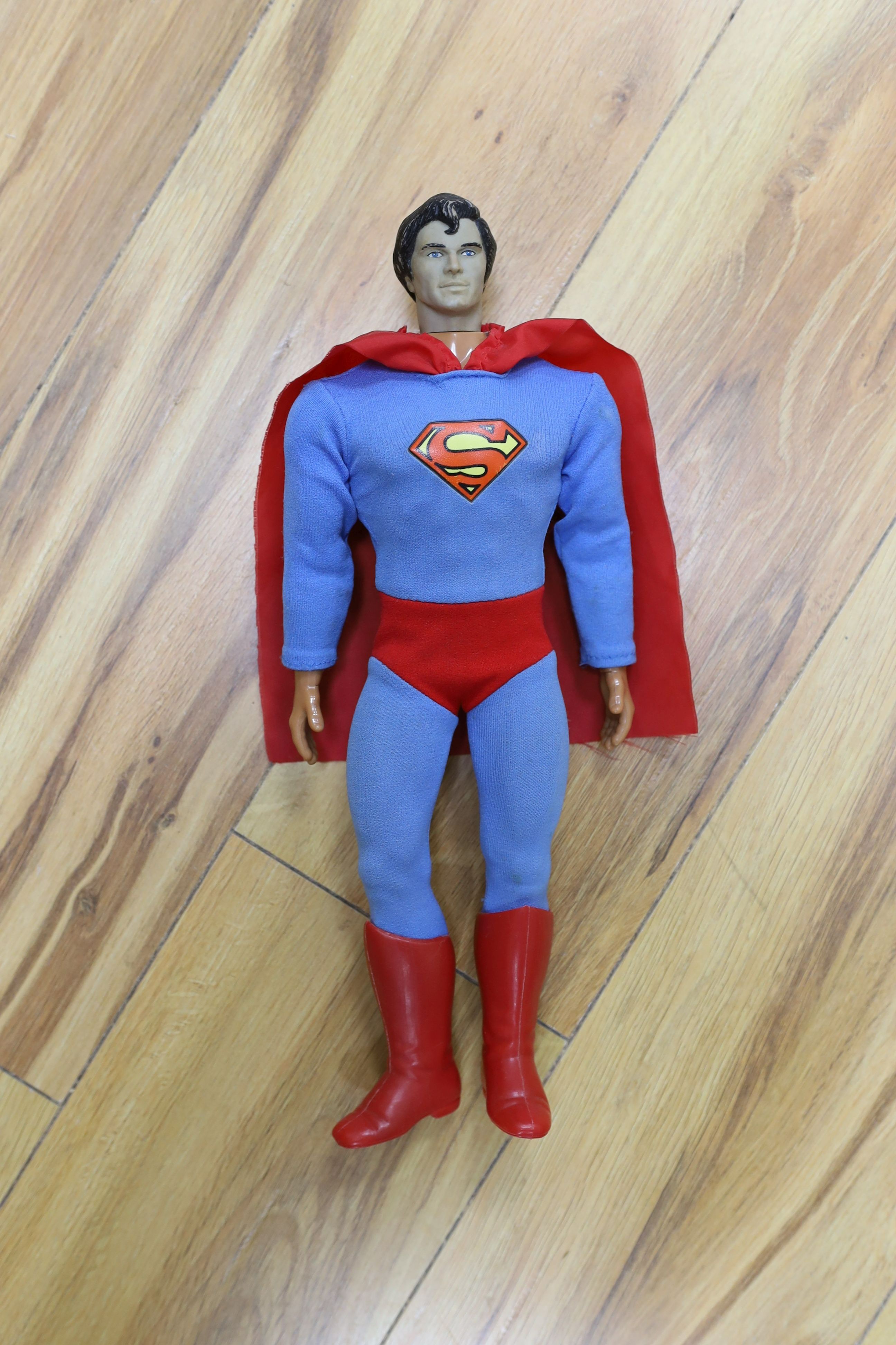 A Denys Fisher Superman, rare in original box, another unboxed, a Unigate milk float with bottles, and a boxed Evel Knievel Stunt Cycle